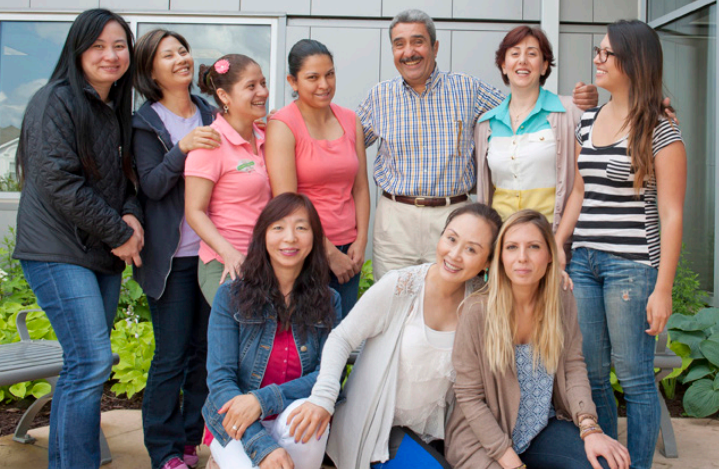 Adult ESOL Students and instructors posing outside during break